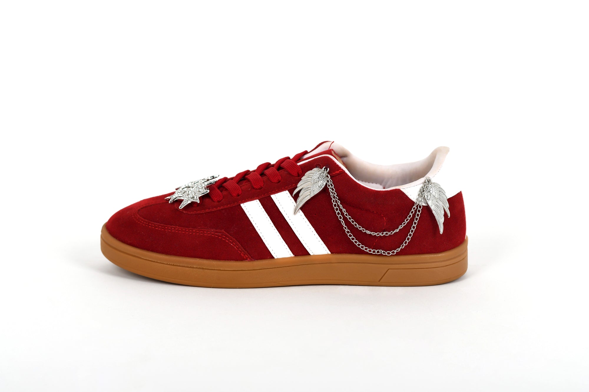 Red sneaker with gold chain and white accents on a white background