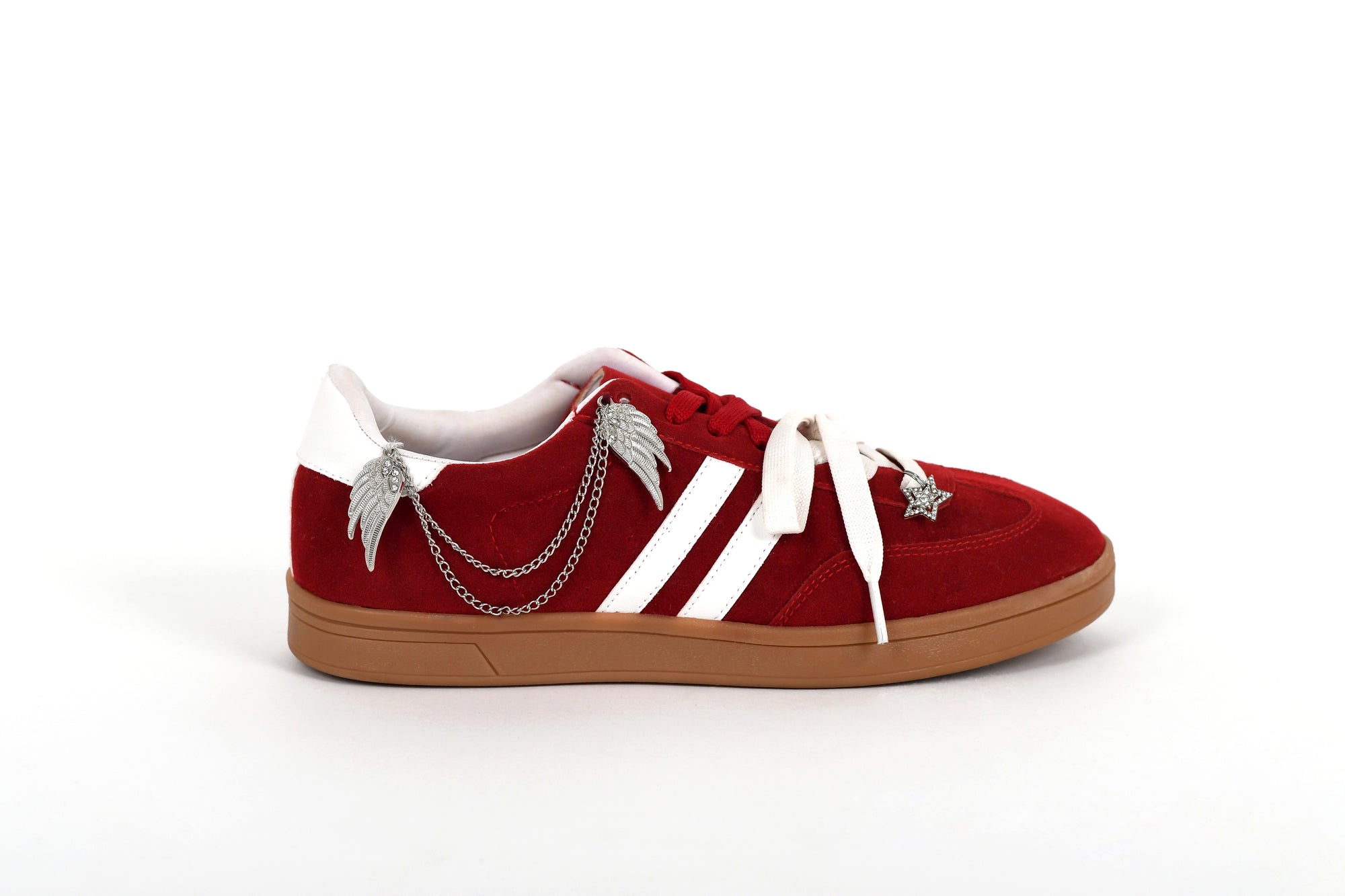 Red sneaker with white laces and chain detail on a white background