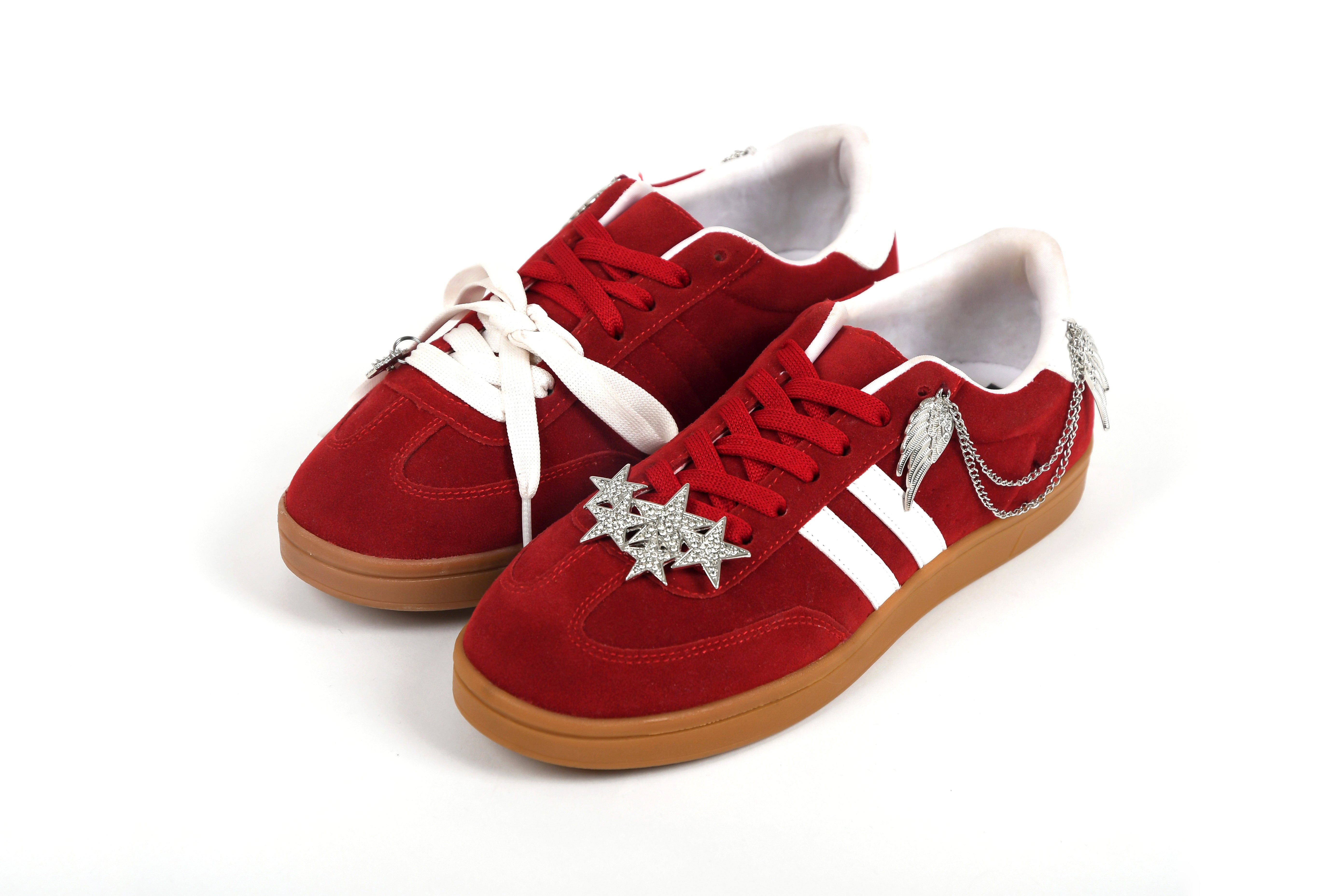 Red sneakers with white laces and soles on a white background